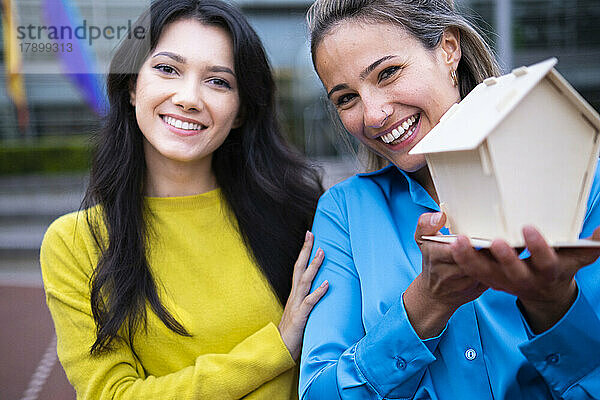 Zwei glückliche junge Frauen mit Musterhaus