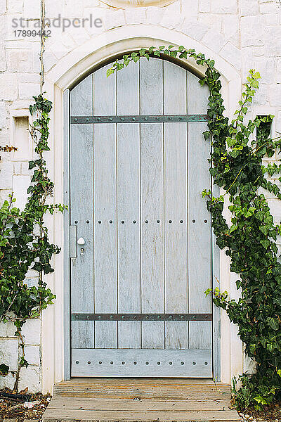 Blaue Haustür mit Pflanzgefäßen auf beiden Seiten