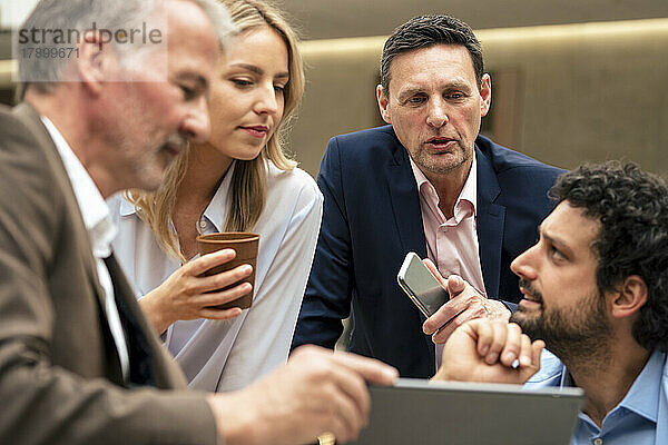 Geschäftskollegen diskutieren über Strategie am Tablet-Computer