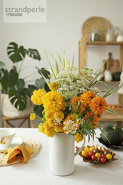 Mehrfarbige frische Blumen in Vase auf dem Tisch zu Hause