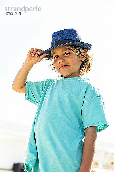 Smiling boy wearing hat on sunny day