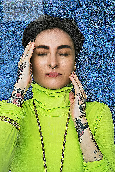 Tattooed hipster woman with eyes closed