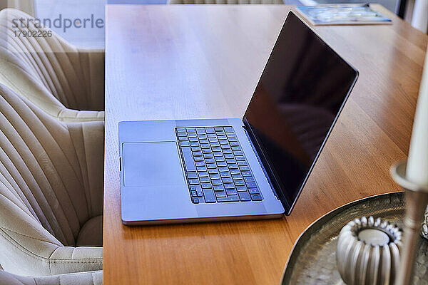 Laptop on dining table at home