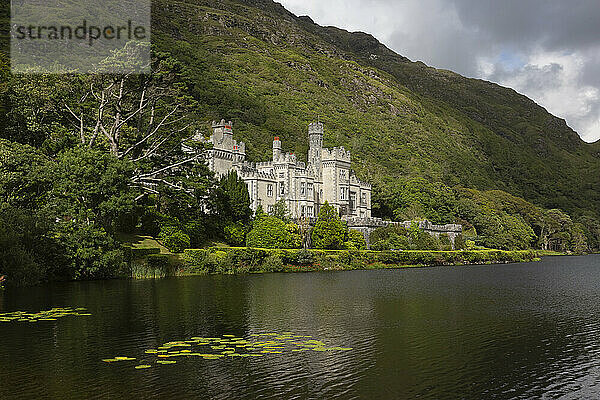 Kylemore Abbey by mountain at Pollacapall Lough lakeshore  County Galway  Ireland