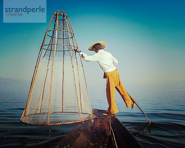 Vintage Retro-Effekt gefiltert Hipster-Stil Bild von Myanmar Reise Attraktion. Traditionelle birmanische Fischer mit Fischernetz am Inle-See berühmt für ihre unverwechselbaren einbeinigen Ruderstil