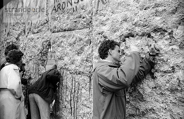 DDR  Berlin  10. 03. 1990. Mauerspechte an der Mauer am Brandenburger Tor