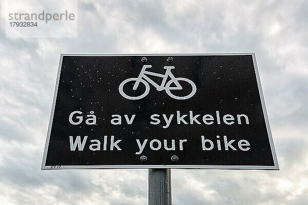 Schwarzweißes Verkehrsschild  zweisprachig mit Piktogramm Fahrrad und Aufschrift Schiebe dein Fahrrad  Radfahrer absteigen  Norwegen  Europa