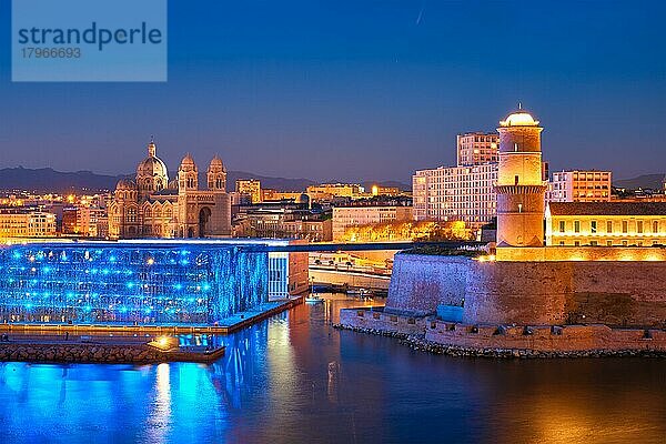 Marseille Old Port and Fort Saint-Jean and Museum of European and Mediterranean Civilisations and Marseille Cathedral illumintaed in night  Marseille  France  Horizontal camera pan