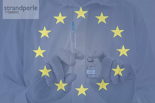 Ein Arzt hält eine Impfstoffflasche und eine Spritze in der Hand  mit der Flagge der Europäischen Union. Beginn der europäischen Massenimpfung gegen das Coronavirus COVID-19 Konzept. Europa-Immunisierung. Selektiver Fokus