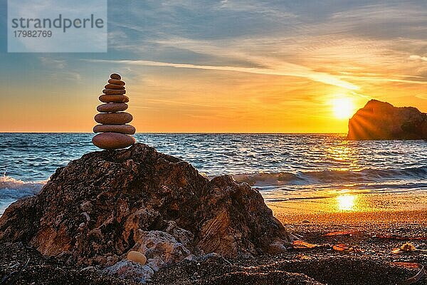 Konzept des Gleichgewichts und der Harmonie  Stapel von Steinen am Strand Küste des Meeres in der Natur bei Sonnenuntergang  Meditative Kunst der Steinstapelung