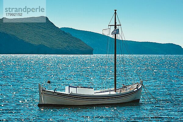 Traditionelles griechisches Fischerboot im Ägäischen Meer mit griechischer Flagge  Insel Milos  Griechenland  Europa