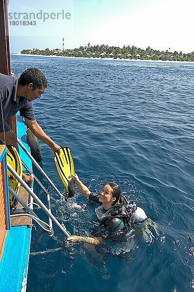Taucherin geht an Bord  Tauchflossen  Flossen  Bootsleiter  helfende Hand  Malediven  Asien