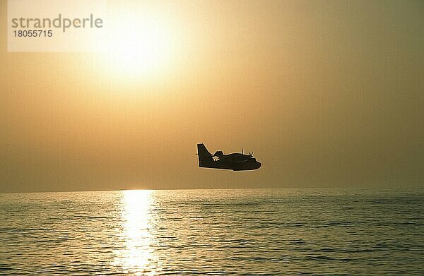 Seaplane over the sea at sunset  Piscinas  Costa Verde  Sardinia  Italy  Wasserflugzeug über dem Meer bei Sonnenuntergang  Costa verde  Sardinien  Italien  Europa  Querformat  horizontal  Europa