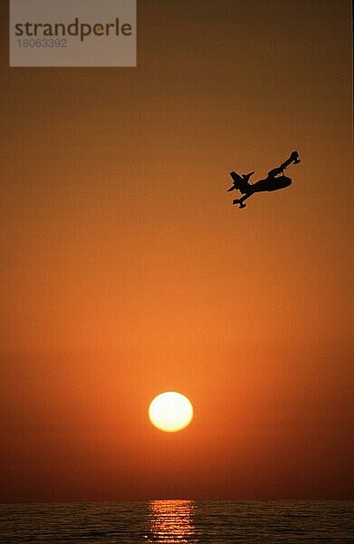 Seaplane over the sea at sunset  Piscinas  Costa Verde  Sardinia  Italy  Wasserflugzeug über dem Meer bei Sonnenuntergang  Costa verde  Sardinien  Italien  Europa  vertical  Europa