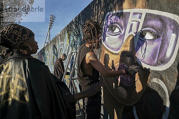 Deutschland  Berlin  27. 03. 2022  Sonntagnachmittag Mauerpark  Graffitimauer  Graffitikünstler Eme Freethinker bei der Arbeit  Lob einer Afrikanerin  Europa