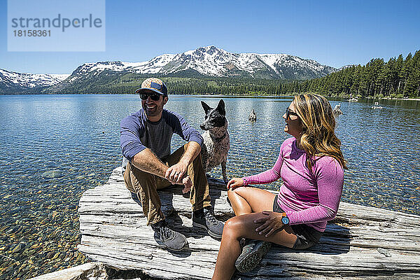 Ein Paar entspannte sich mit seinem Hund am Ufer des Fallen Leaf Lake.
