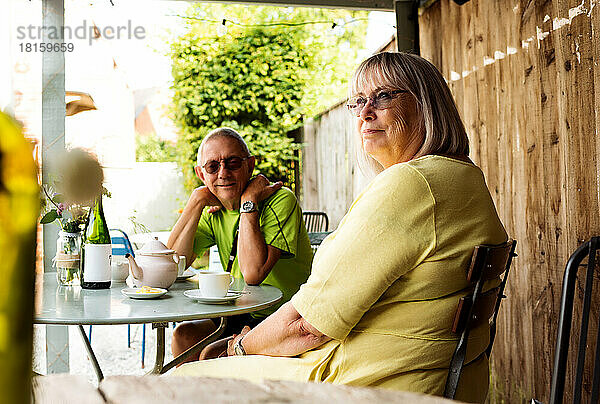 Ehepaar im Ruhestand sitzt glücklich bei Kaffee und Tee in einem Café