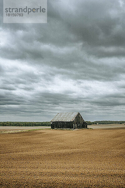Alte verlassene verwitterte Scheune inmitten eines Farmfeldes in Kentucky
