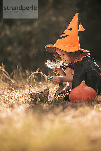 kleines Mädchen feiert Halloween in der Natur Kürbis