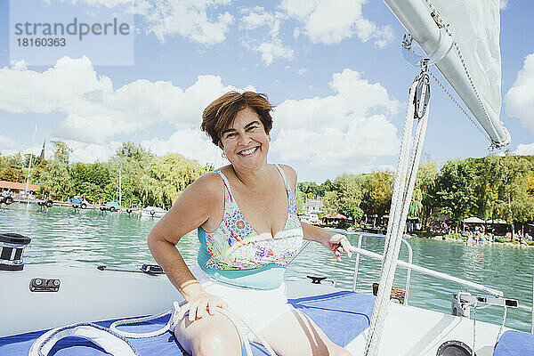 Glückliche Frau genießt den Urlaub auf einem Segelboot