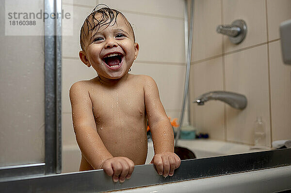 Happy baby boy in bathtub