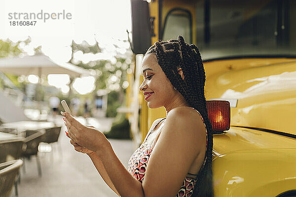 Smiling young woman using smart phone