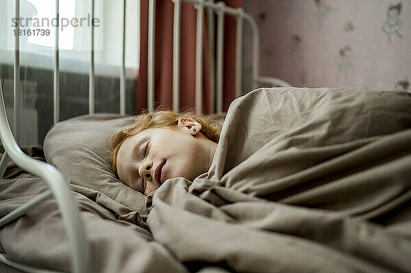 Girl sleeping in bed at home