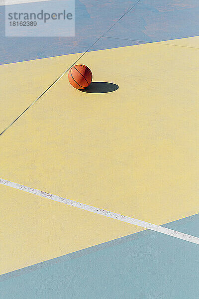 Basket ball in court on sunny day