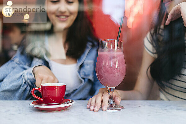 Junge lesbische Freunde genießen Getränke im Café