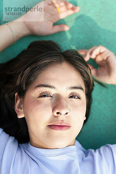Young woman lying on sports court