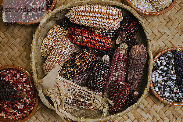 Basket with different varieties of corn cobs