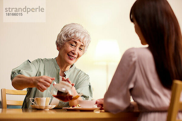 Ältere und junge japanische Frauen genießen die Teezeit