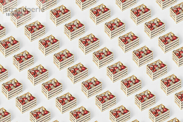 Seamless pattern of wooden boxes with christmas baubles on white background
