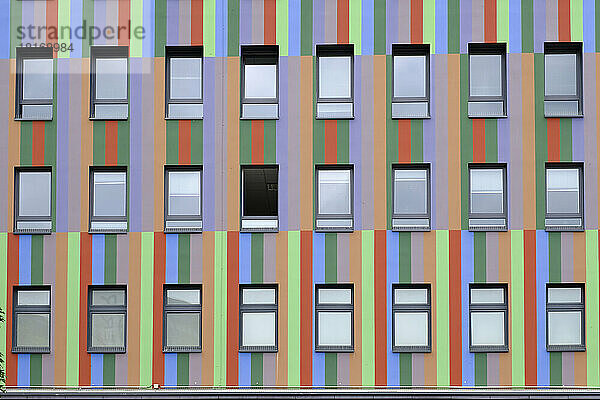 Rows of windows of colorful striped building