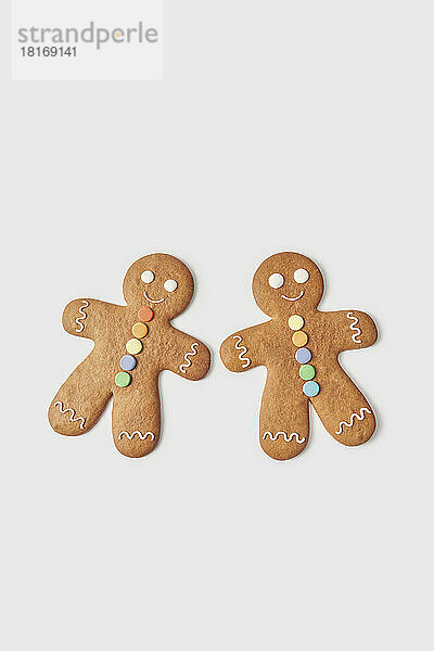 Pair of gingerbread man cookies against white background