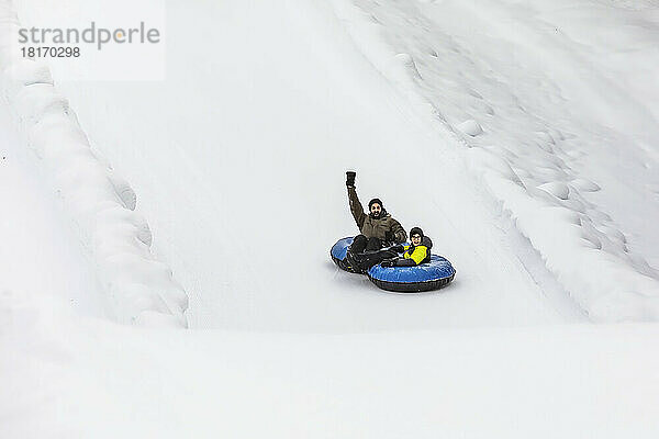 Vater und Sohn fahren im Tandem einen Skihang hinunter; Fairmont Hot Springs  British Columbia  Kanada