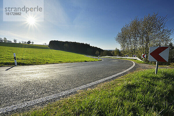 Winding Country Road with Sun in Spring  Neudorf  Amorbach  Odenwald  Bavaria  Germany
