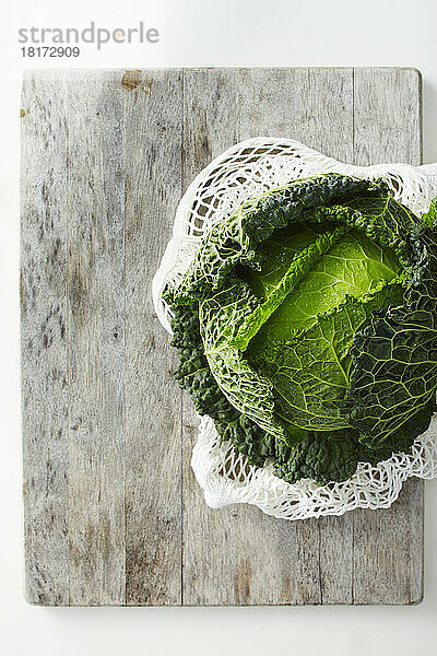 Overhead View of Savoy Cabbage on Wooden Cutting Board  Studio Shot