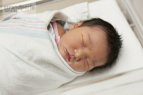Newborn Baby Girl in Hospital Bassinet