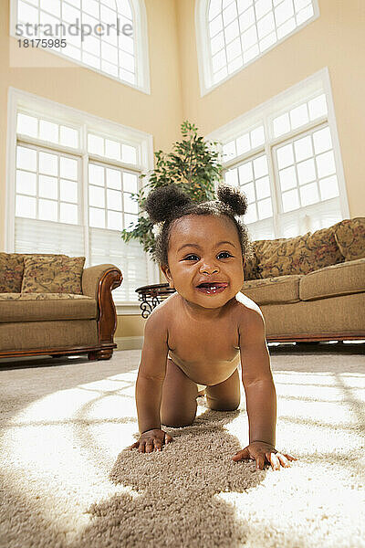 Smiling Baby Girl with Pigtails Crawling around Family Room