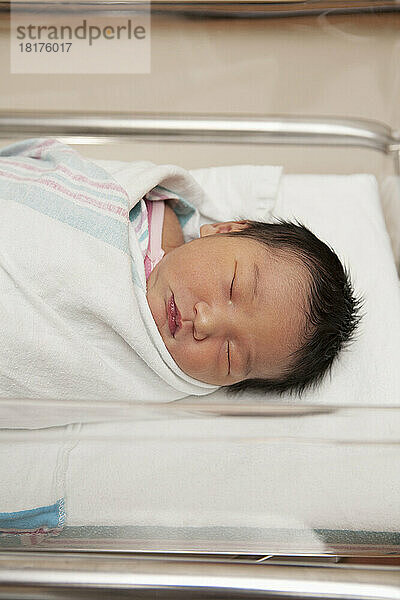Newborn Baby Girl in Hospital Bassinet