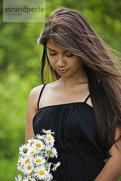Woman Holding a Bouquet of Daisies