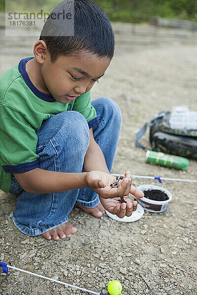 Crouching Boy Preparing Worm for Fishing  Lake Fairfax  Reston  Virginia  USA