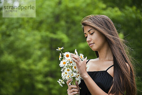Woman Holding a Bouquet of Daisies