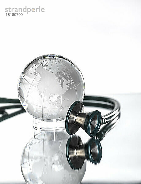Studio shot of stethoscope pointed at glass globe