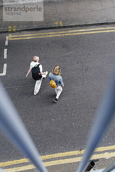 Lesbian couple walking together on urban street