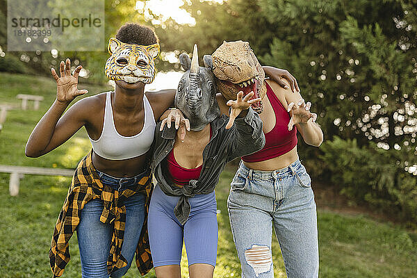 Glückliche Frauen mit Tiermaske  die Spaß im Park haben