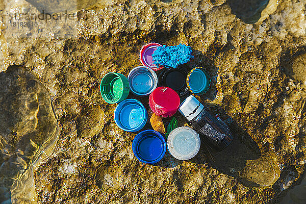 Bottle caps and garbage at beach on sunny day