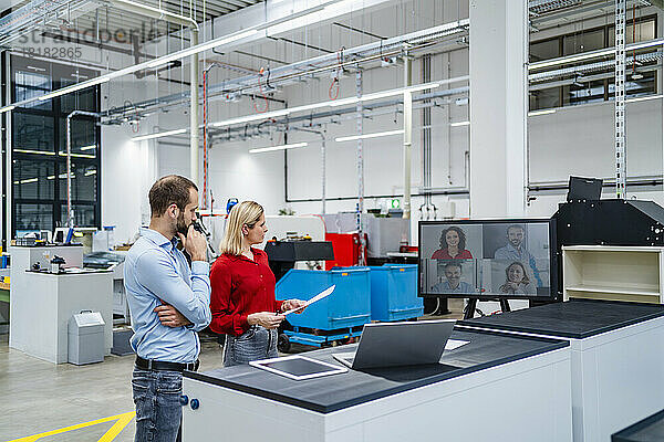 Geschäftskollegen führen Videokonferenzen auf dem Computerbildschirm in der Fabrik durch