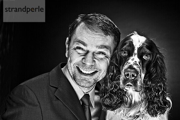 Portrait of mature man with English Springer Spaniel  smiling